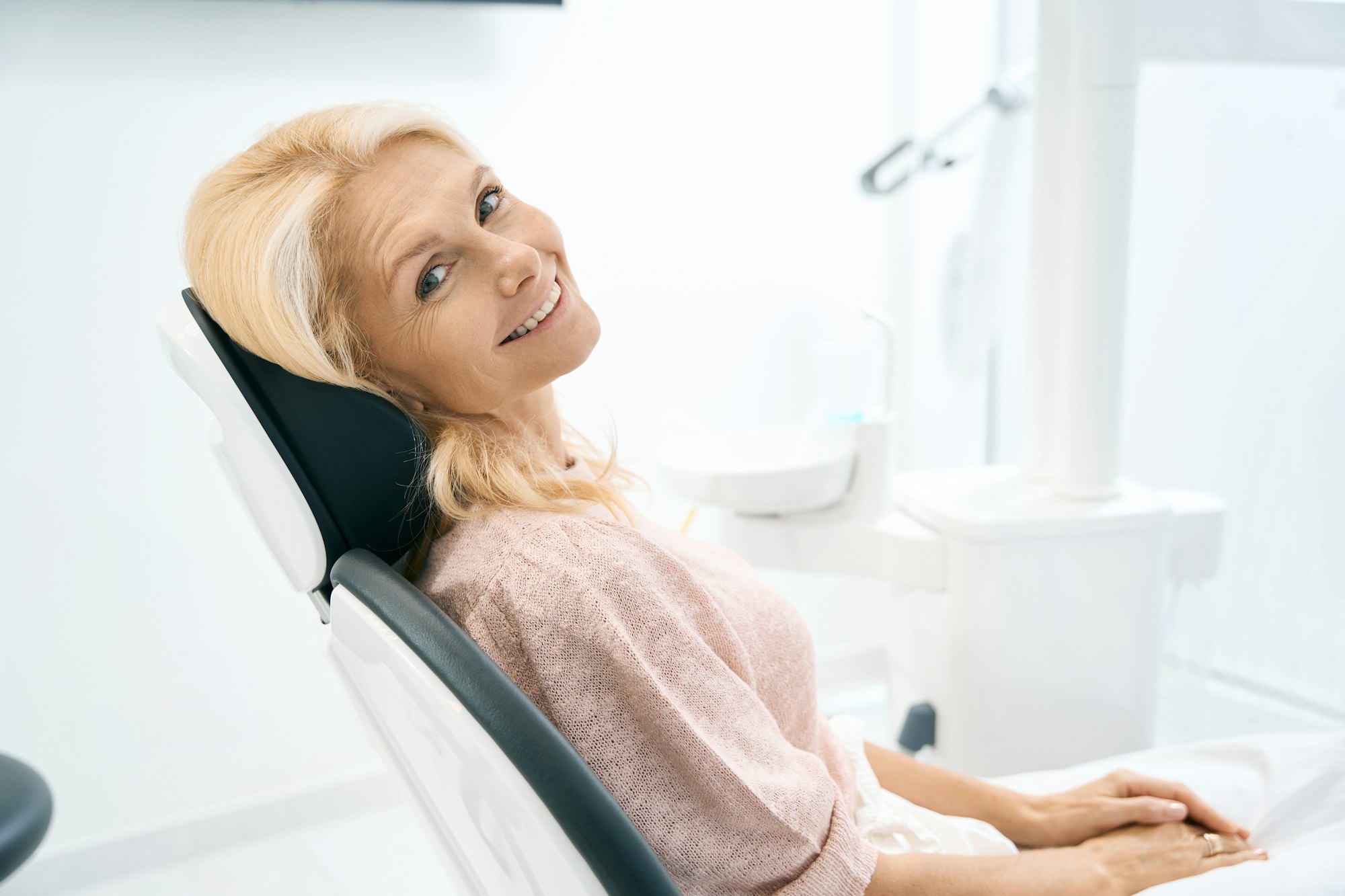 Pretty woman sitting at the dental cabinet